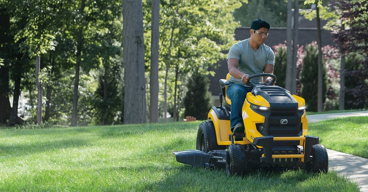 man on cub cadet riding-turn mower cutting grass