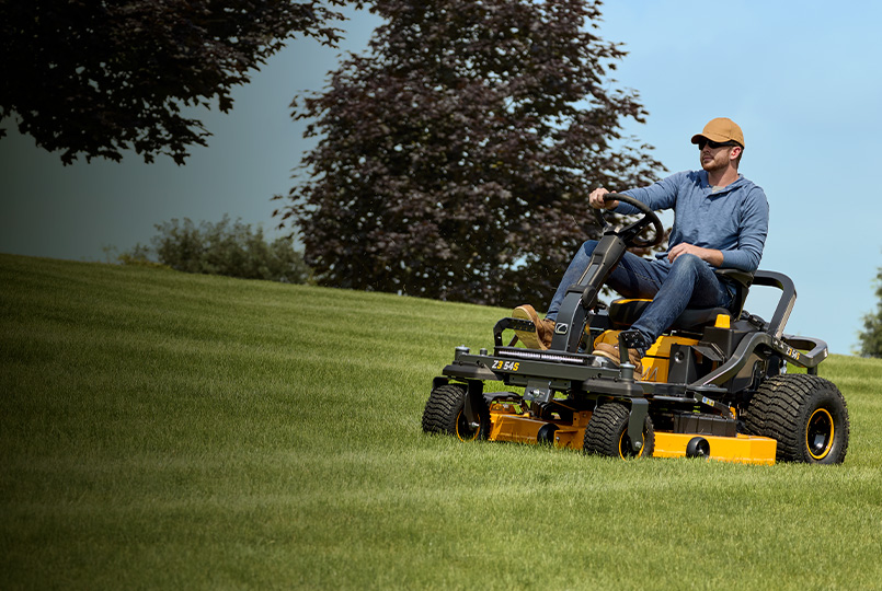 man on cub cadet zero-turn mower cutting grass
