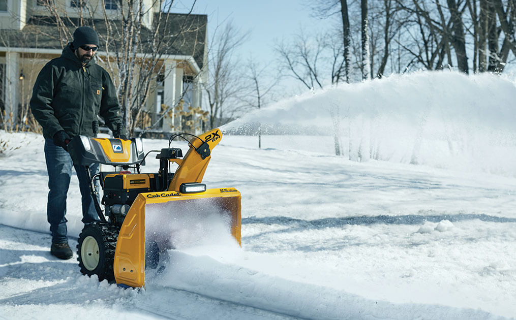 Man snow blowing his driveway