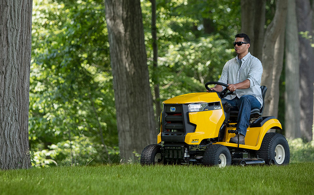 Man cutting the grass with a lawn tractor