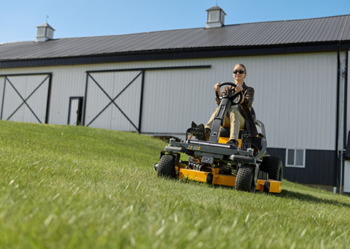 woman on a zero turn mower with steering wheel