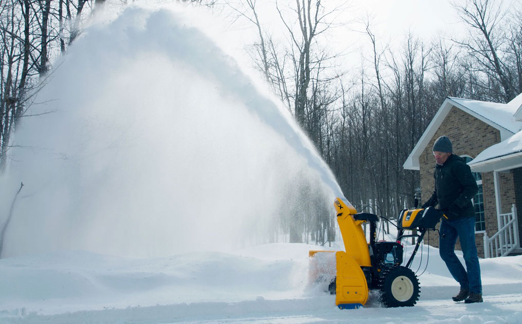 Man snow blowing his driveway