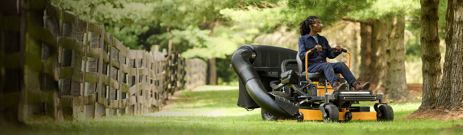woman on zero trun lawn mower