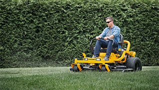 zero-turn mower cutting grass