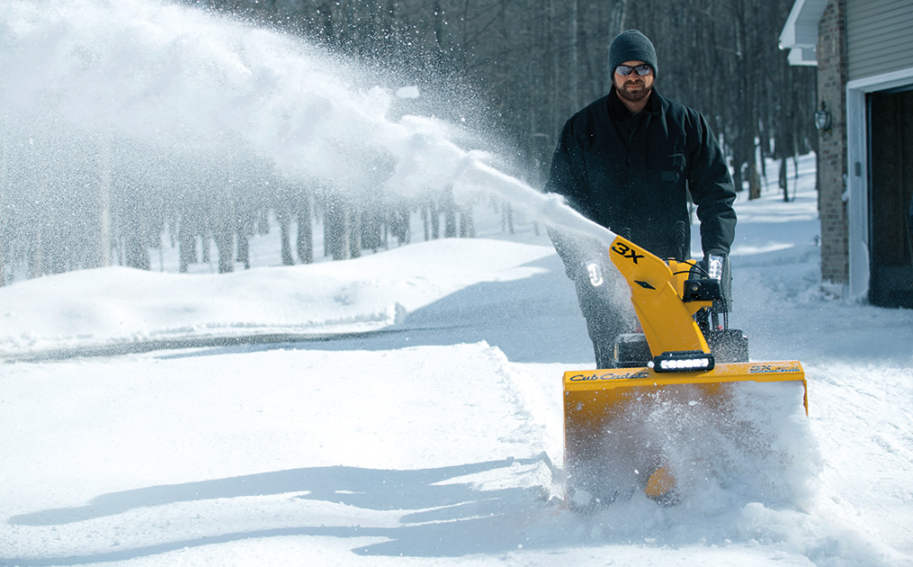 Man snow blowing his driveway