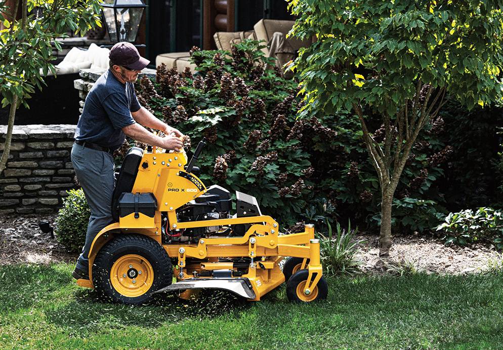 man operating stand on professional mower