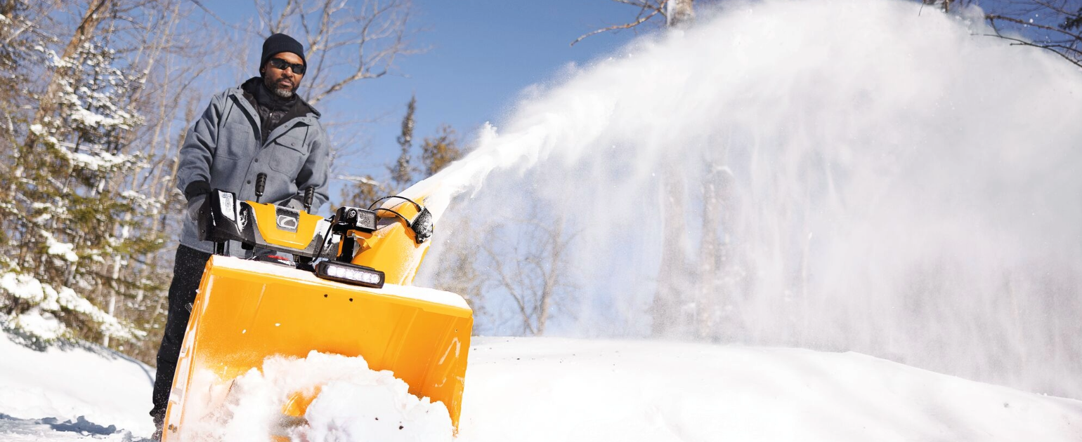 man using snow blower