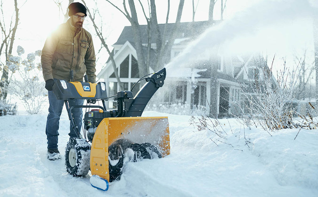 man-blowing-snow