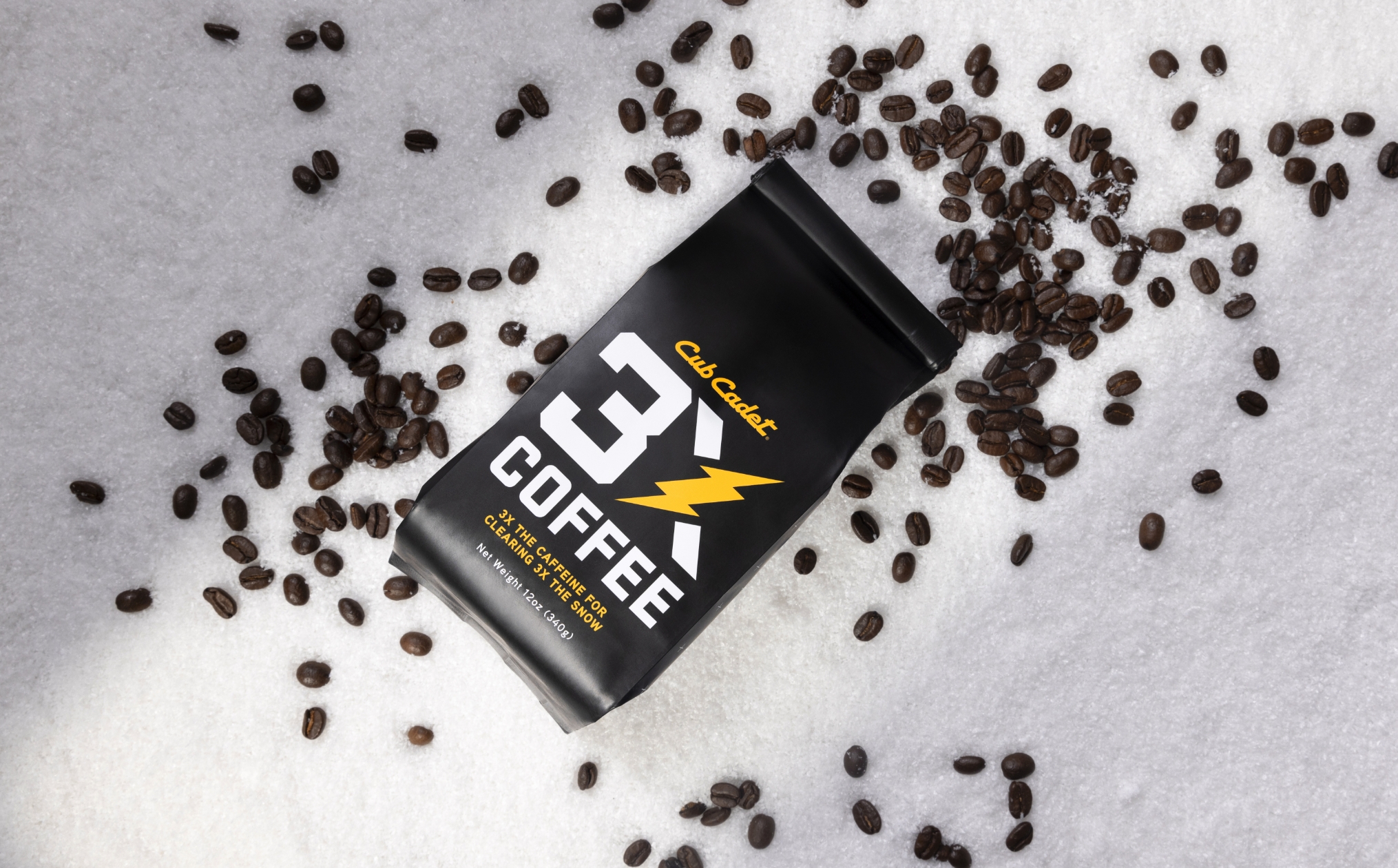 3X coffee and coffee beans sitting in snow