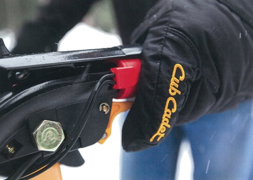pushing the trigger control for the snow blower power steering