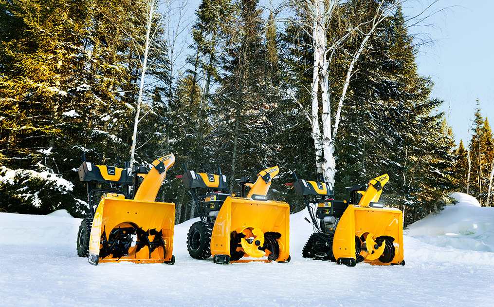 All three sizes of snow blowers sitting in snow