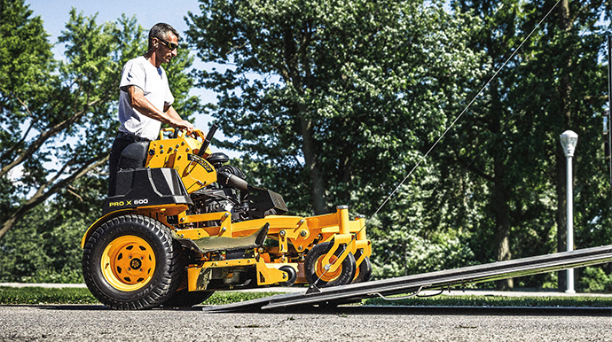 man using commerical stand on mower
