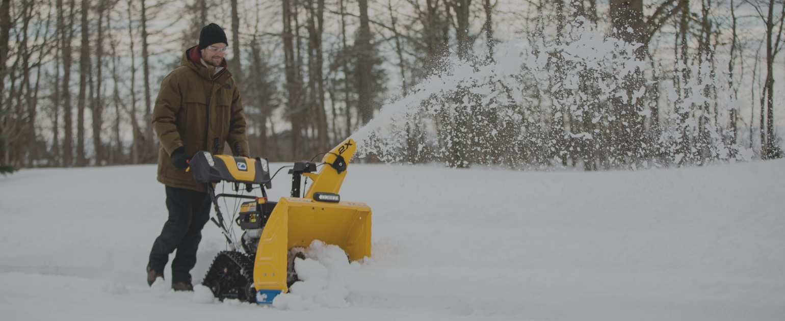 man using snow blower