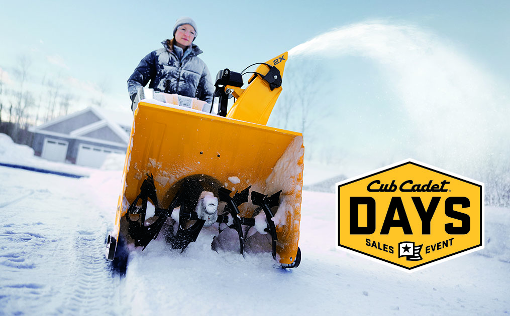 Woman pushing snow blower through heavy snow