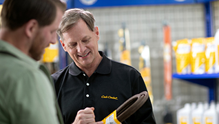 image of dealer showing parts to a customer